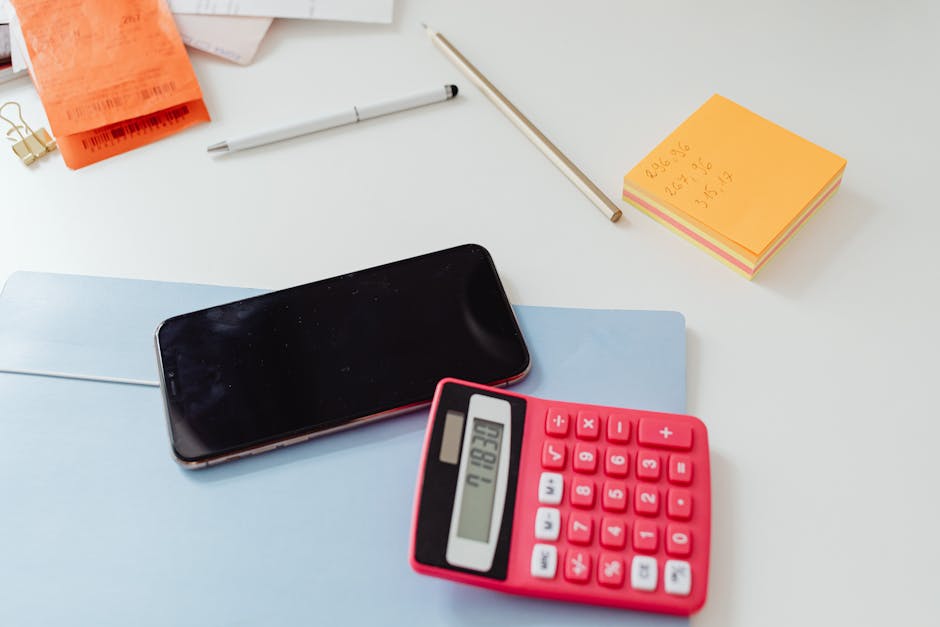 Pet insurance deductible explained with a calculator and policy paperwork: a close-up of a calculator, pen, and policy document on a clean desk, the kind of careful financial review where pet insurance deductible explained on paper turns into a defensible written household budget for the upcoming policy year