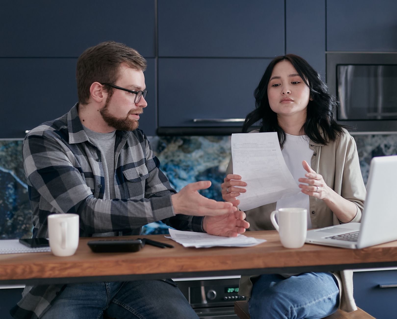 Pet owner reviewing policy paperwork with a dog nearby, weighing whether pet insurance covers cancer